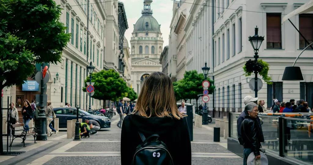 The back of a female walking towards St. Stephen's Basilica in Budapest, Hungary