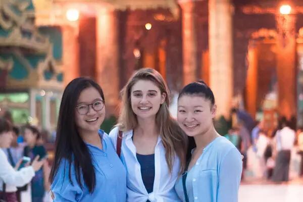 3 CAS students stand in front of a temple in Myanmar