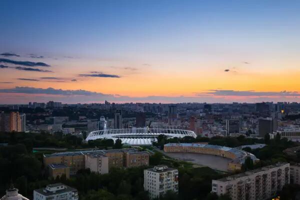 Kyiv skyline and Olympic stadium at sunset 