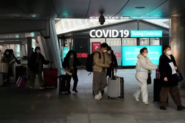 Passengers arriving from China pass by a COVID-19 testing centre at the Incheon International Airport, on Jan. 10.