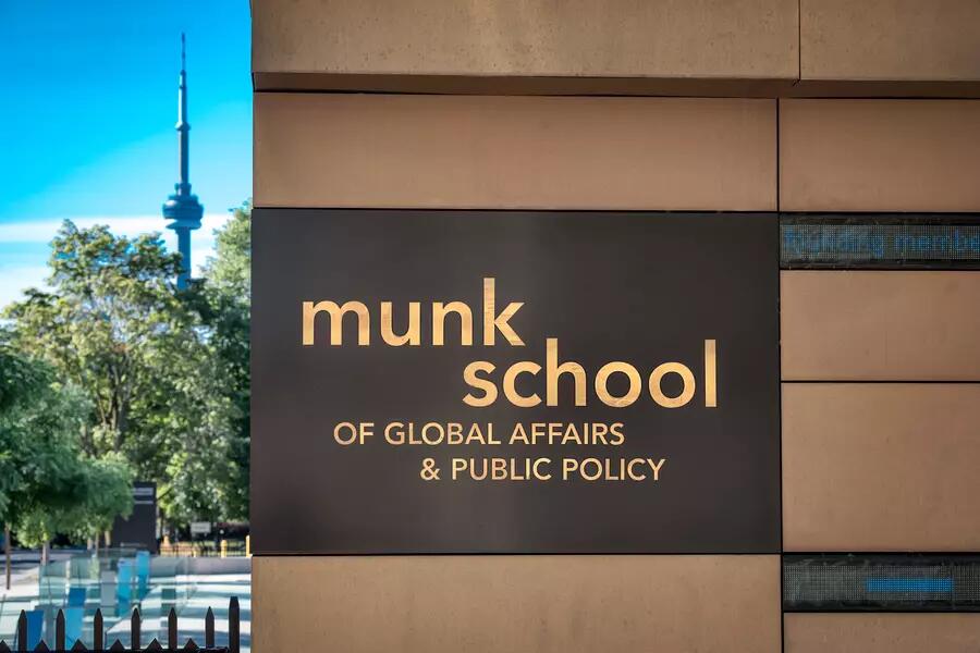 The Munk School sign with the CN Tower in the background