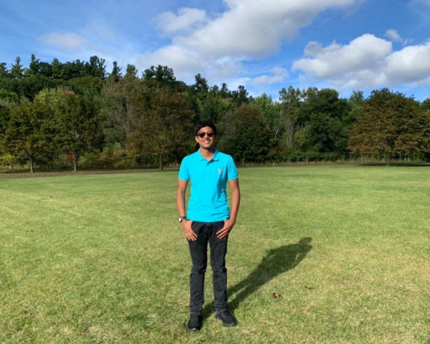 Atharv Agrawal standing in front of a green background.