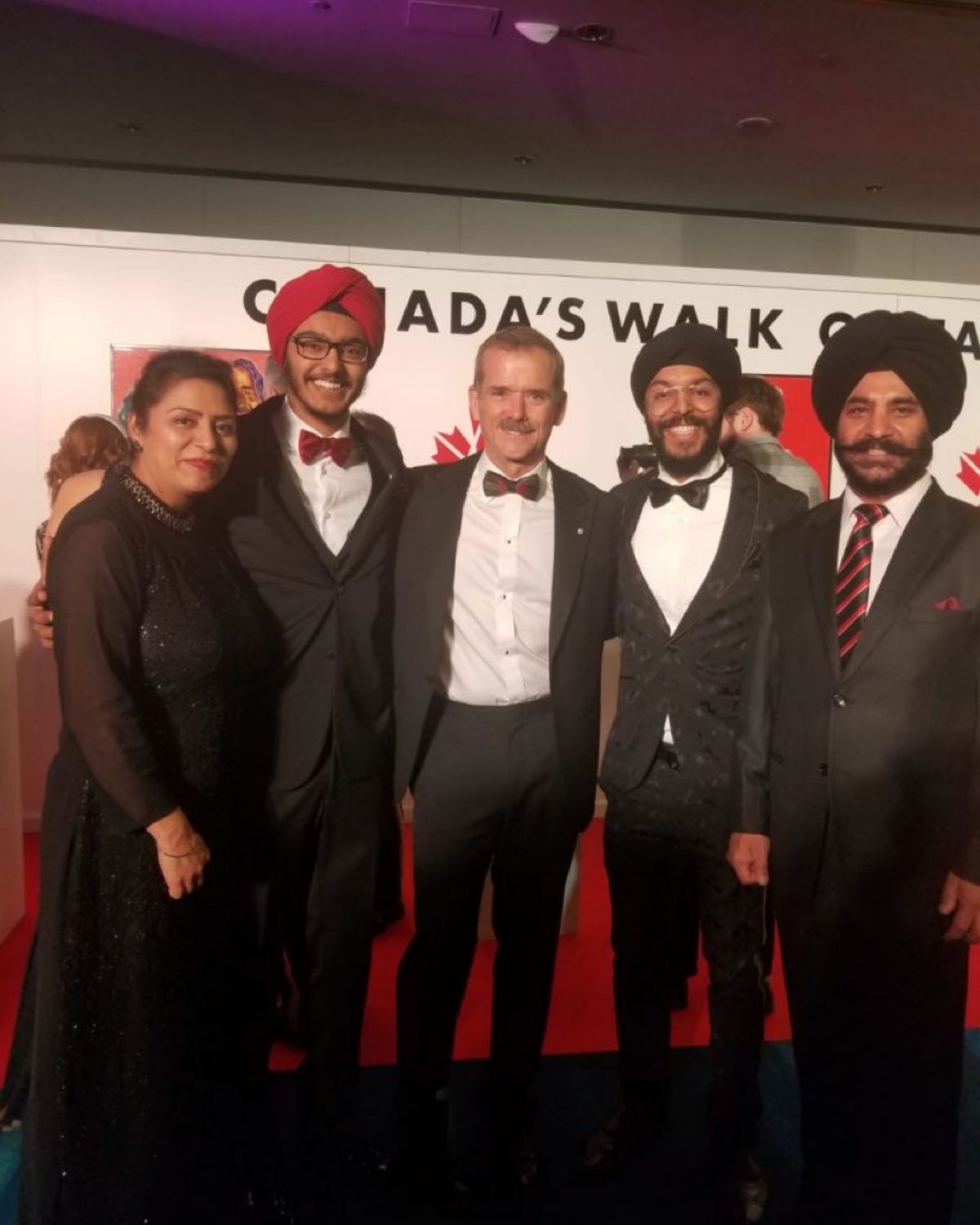 Abhayjeet Singh Sachal and his family meeting Chris Hadfield, all in evening wear.