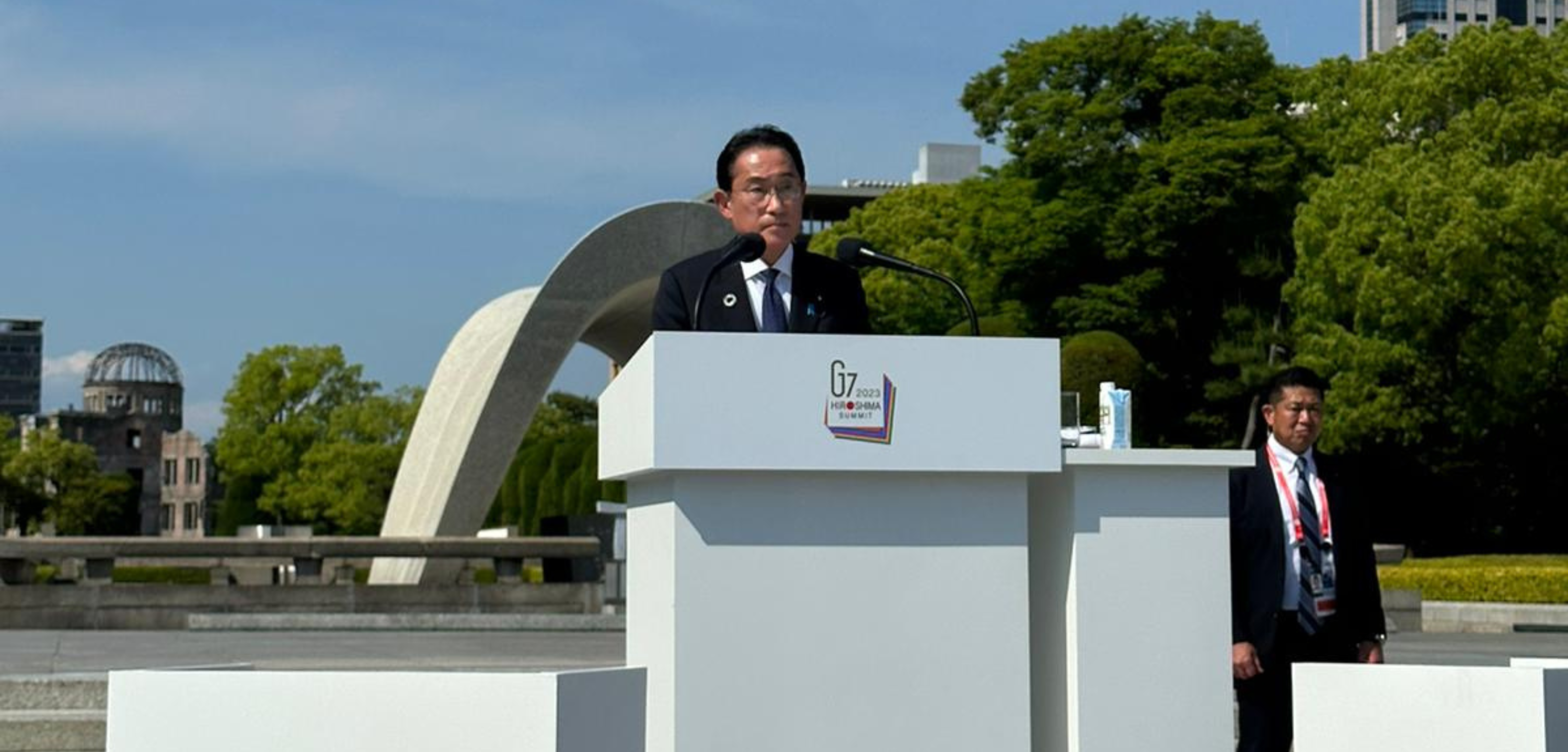 Prime Minister of Japan, Fumio Kishida, stands behind a podium while addressing attendees of the G7 2023 Summit