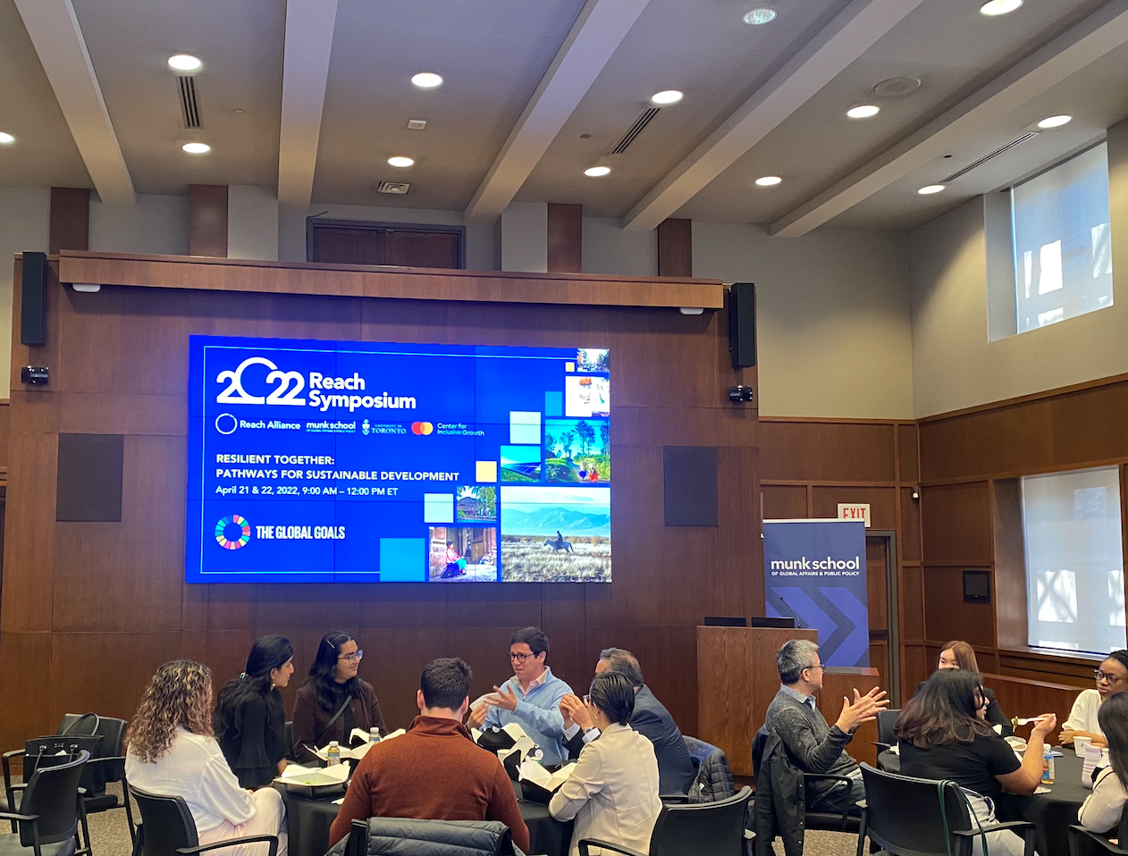 2022 Reach Symposium attendees in discussion at the University of Toronto’s Munk School. Source: Reach Alliance