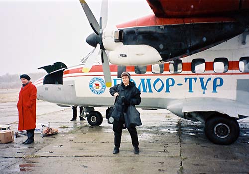 Lynne Viola standing in front of a propeller plane