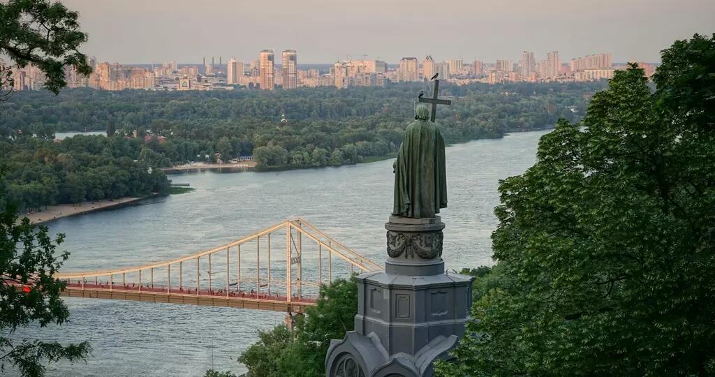 Bridge' river and statue with Kyiv in the background