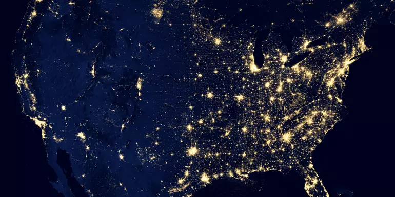 Photo of earth from space with lights of populated areas