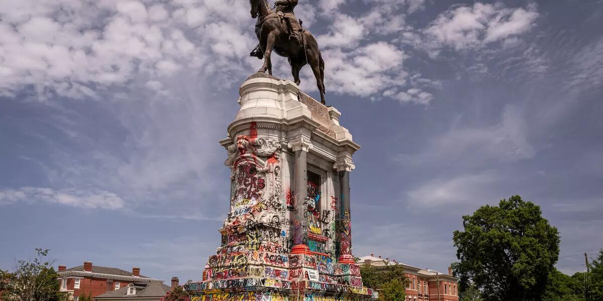 A statue of Robert E Lee covered in graffiti