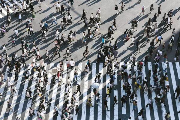 Arial photo of lots of people crossing a large intersection