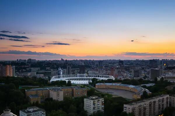 Kyiv skyline at dusk with view of stadium