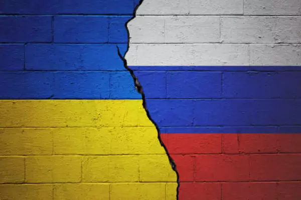 Ukraine and Russia Flag with fissure in the middle of the photo