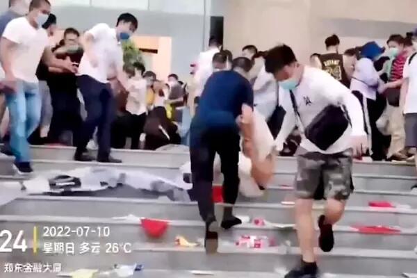 An image from social media shows men in white shirts dispersing protesters in Zhengzhou, China, on July 10. (Reuters)