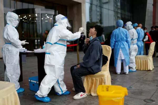 A man gets tested for the coronavirus disease (COVID-19) at a makeshift nucleic acid testing site outside a hotel in Wuzhou, Guangxi Zhuang Autonomous Region, China March 24, 2022. REUTERS/Carlos Garcia Rawlins