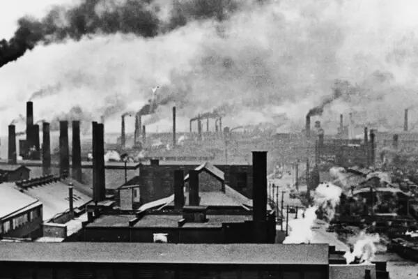 Image of industrialized city, with smoke stacks and smoke filling the air