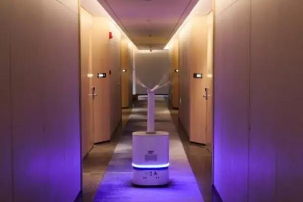 A robot moves through the hallway of a hotel spraying disinfectant against the coronavirus disease (COVID-19) ahead of the Beijing 2022 Winter Olympics, in Yanqing