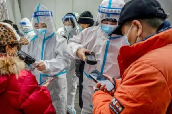 Citizens having their phones scanned by sanitation workers in China
