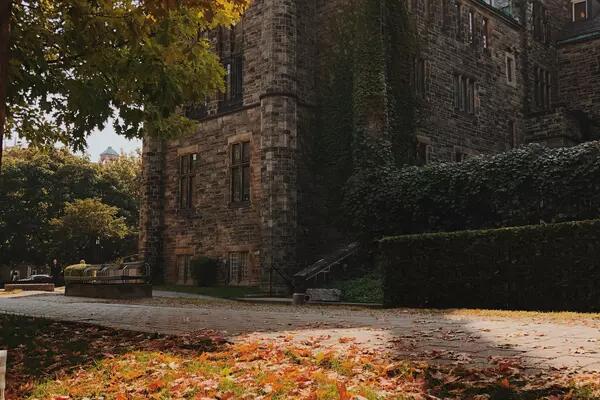 Shot of a stone building on the University of Toronto campus in the fall.