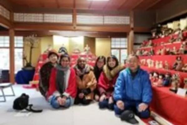 Group of people learning about the Hinamatsuri festival with host family