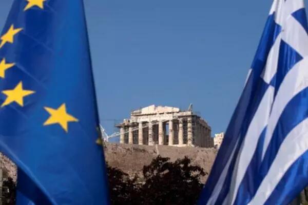 Greece and European Union flags with an old building in the background