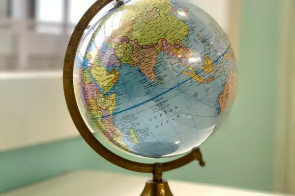 A globe sitting on a white countertop.