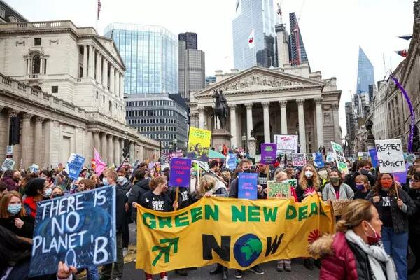 Protesters carrying signs relating to the Green New Deal and "There is no Planet B"