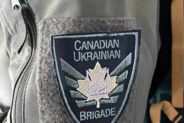 Canadian Ukrainian Brigade Badge with a maple leaf that has a tryzub in the middle with stripes coming out of it on both sides