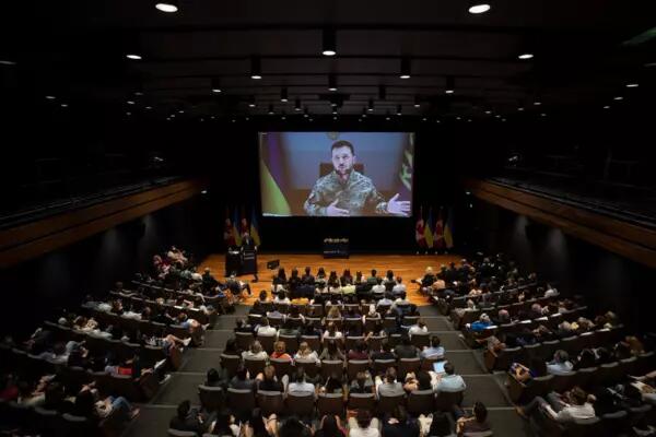 President Zelenskyy gives a live video address to a full auditorium