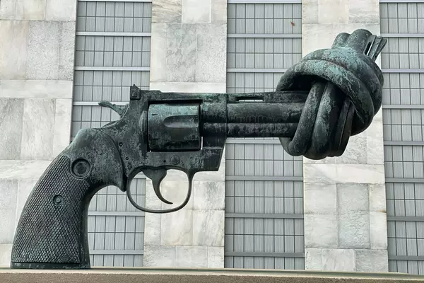 A stone statue of a gun with its barrel twisted, so it cannot fire