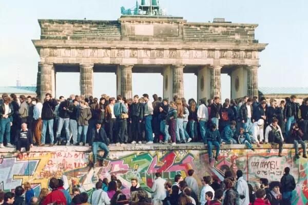 People on top of the fallen Berlin Wall
