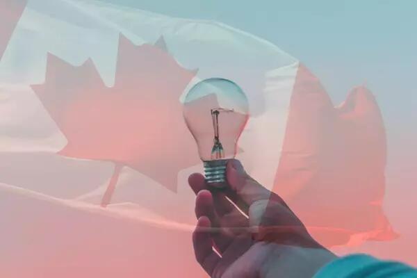 Image of an outstretched hand holding a lightbulb and an image of the Canadian flag overlaid so that both are visible