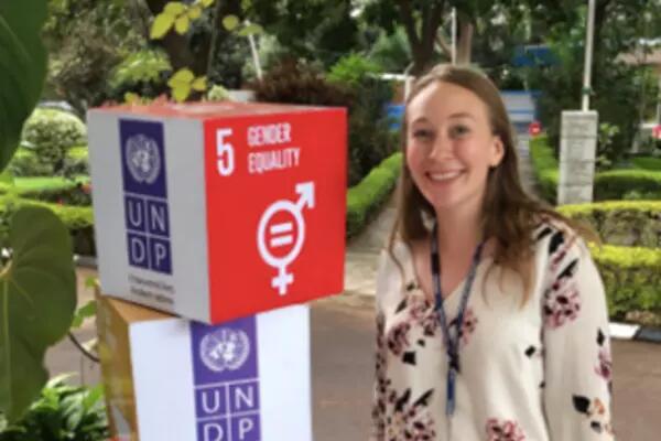 Jenna Lemieux standing next to a UNDP display