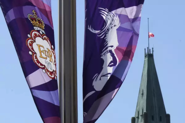 Queen Elizabeth II on a banner with Canadian parliament in the backrground