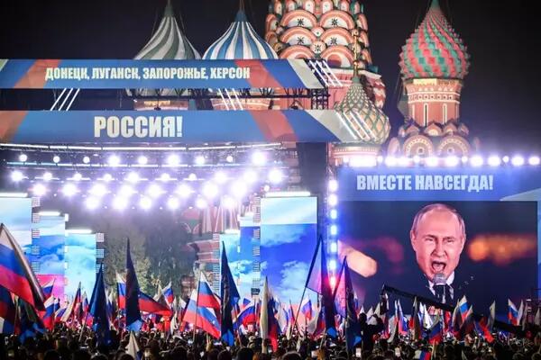 Russian President Vladimir Putin is seen on a screen set at Red Square as he addresses a rally and a concert marking the annexation of four regions of Ukraine in central Moscow on Sept. 30, 2022.  AFP CONTRIBUTOR#AFP / AFP VIA GETTY IMAGES