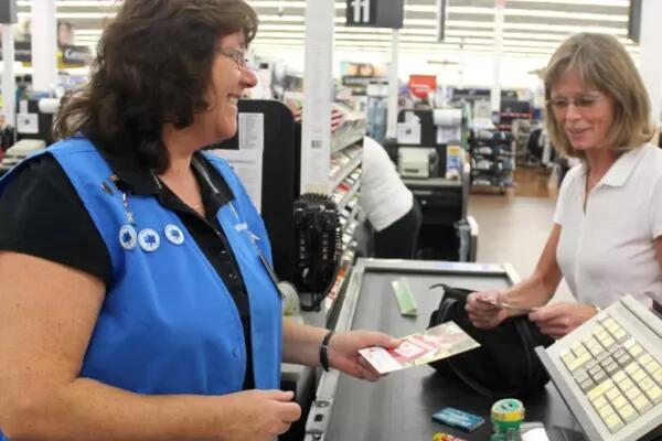 A woman cashier checks out another woman at Walmart
