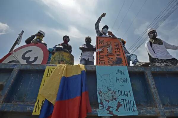 Demonstrators in Cali, Colombia, shout anti-government slogans as they continue a blockade at the Sameco sector during a protest amid a national strike on May 19, 2021. Gabriel Aponte/Getty Images
