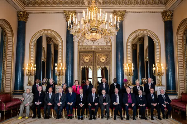 King Charles, front row centre, sits with members of the Order of Merit at Buckingham Palace in London on Thursday. Among the members are Canadian historian Margaret MacMillan, back row second from left, and former prime minister Jean Chrétien, front row second from left. (Aaron Chown/AFP/Getty Images)