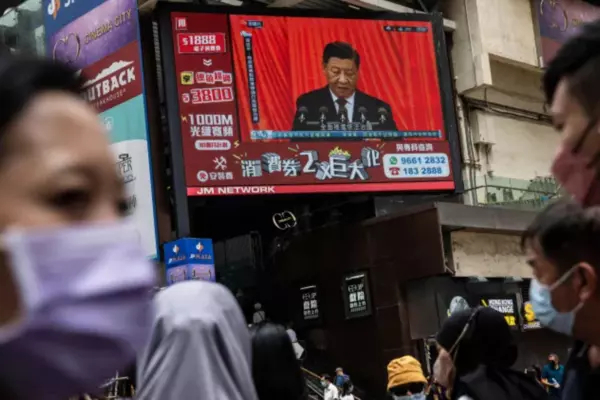 Chinese President Xi Jinping is seen on a TV screen above a street in Hong Kong on Oct. 16, 2022. For nearly three years, China's strict zero-COVID policy has forced lockdowns, quarantines, tests and travel bans on 1.4 billion people. (Isaac Lawrence/AFP/Getty Images)