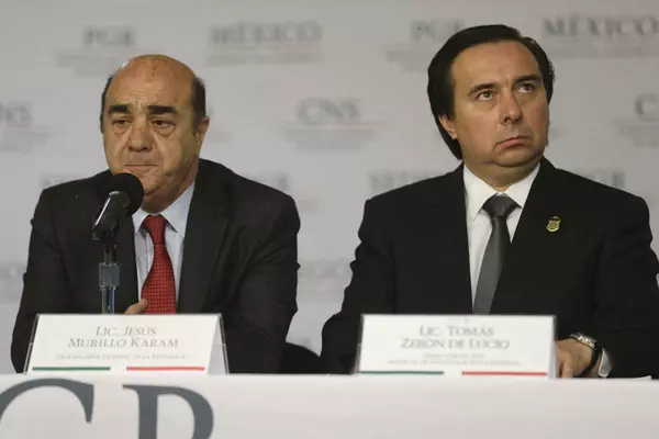 Former Mexican Attorney General Jesus Murillo Karam (left) stands next to Tomas Zeron, former director of the Mexican Criminal Investigation Agency. Mexico City, October 9, 2014. TOMAS BRAVO / REUTERS