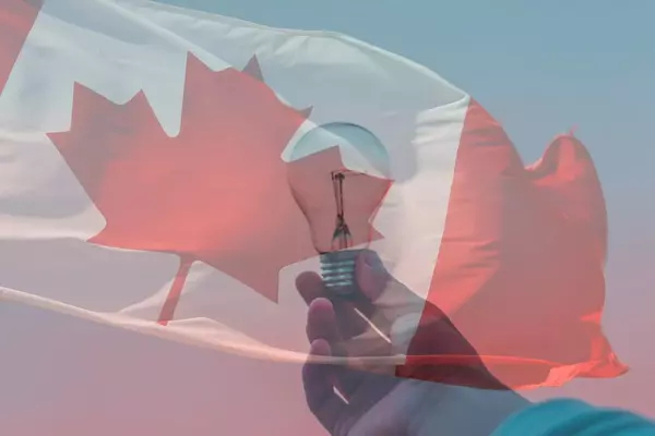 Canadian flag against a person holding a lightbulb