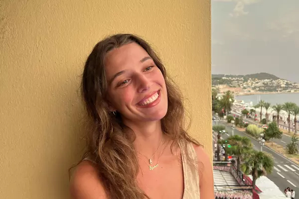 Picture of American Studies student Irene Anastasiadis standing on a balcony wearing a tank top.