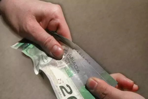 Someone handed another person a 20 dollar bill (close up on hands)