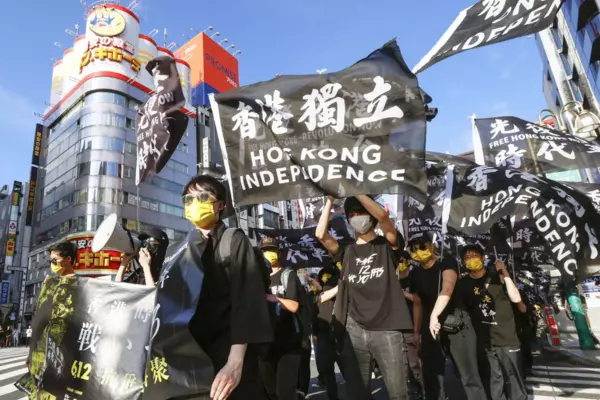 Hong Kong residents demonstrate in Tokyo's Shinjuku area on June 12, 2021, on the second anniversary of the large-scale anti-extradition bill protests in their home city. | KYODO