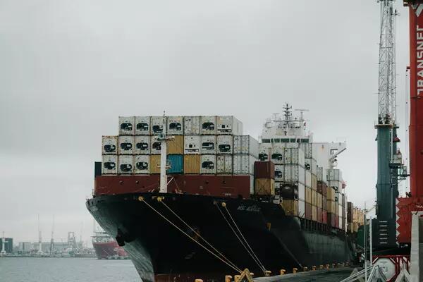 A cargo ship loaded with containers sits in a South African port.