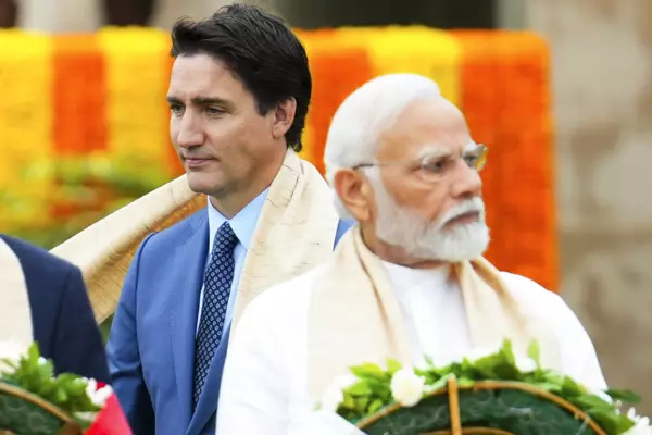 Prime Minister Justin Trudeau, left, walks past Indian Prime Minister Narendra Modi as they take part in a wreath-laying ceremony at Raj Ghat, Mahatma Gandhi's cremation site, during the G20 Summit in New Delhi, on Sept. 10.