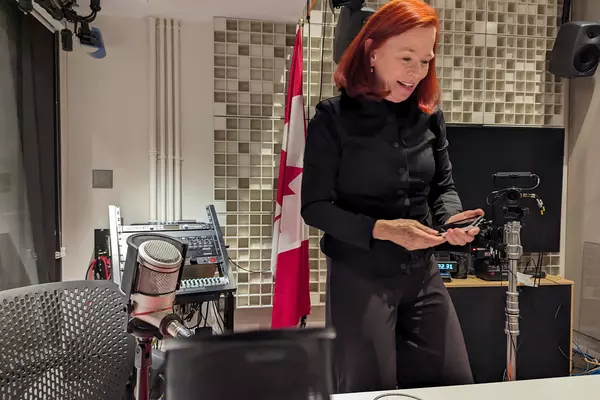 Catherine Tait on her phone while standing