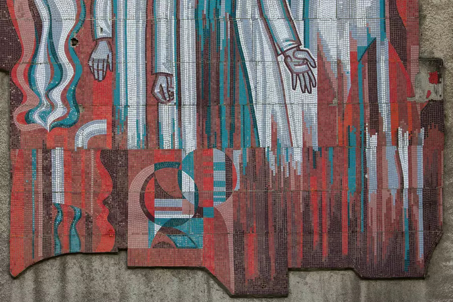 Close up of a mural of arms reaching down