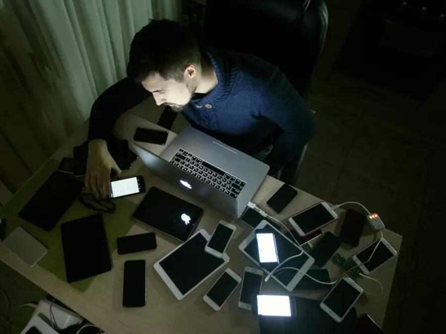 Man surrounded by various devices