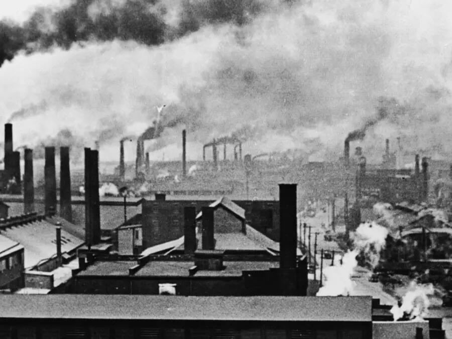 Image of industrialized city, with smoke stacks and smoke filling the air