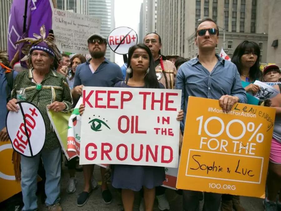 Woman carries a placard stating 'Keep the Oil in the Ground' whilst demonstrating for environmental awareness during the 2014 People's Climate March through Manhattan, New York, USA.